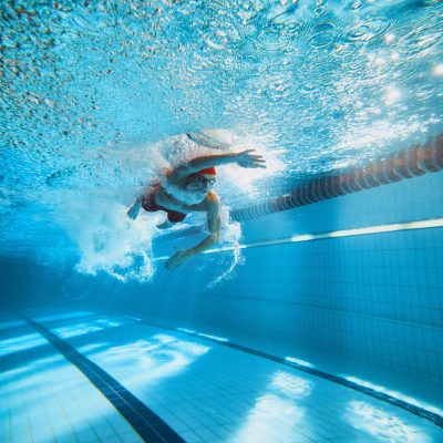 Dynamic,Image,Of,Young,Man,,Swimmer,In,Motion,,Swimming,Freestyle